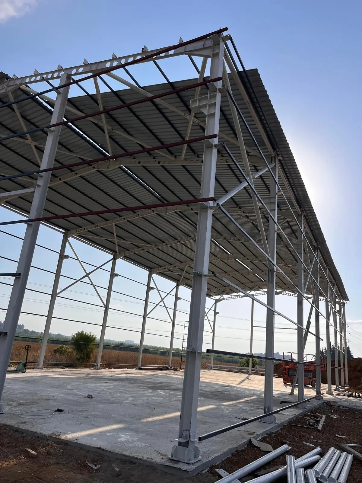 Primary frames and roof cladding of a steel warehouse.
