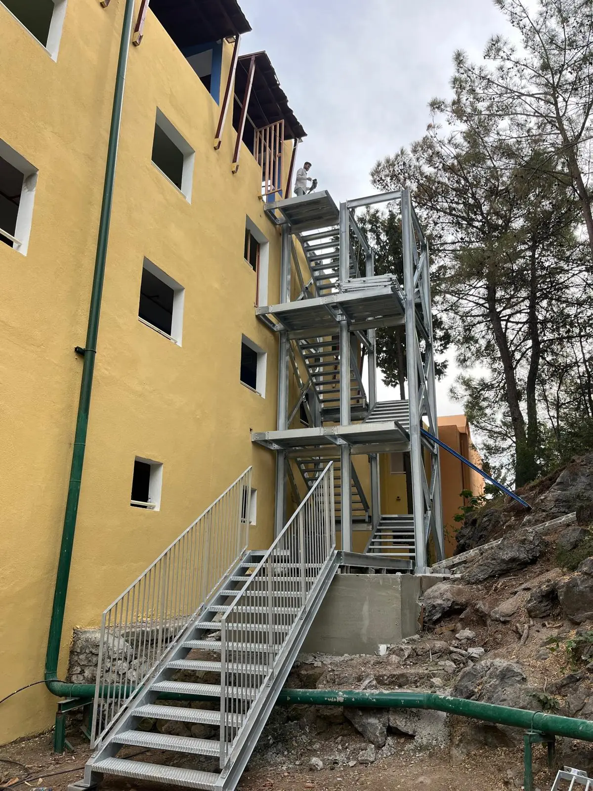Finished external fire escape: steel tower, landings and the flight down to the ground.